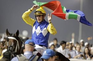 Proudly SA! Christophe Soumillon holds the SA flag aloft