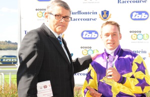 Trophy Time. RA CEO Larry Wainstein presents winning rider Marco Van Rensburg with the trophy