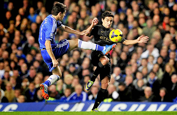 Oscar (L) vies and Jesus Navas (R)