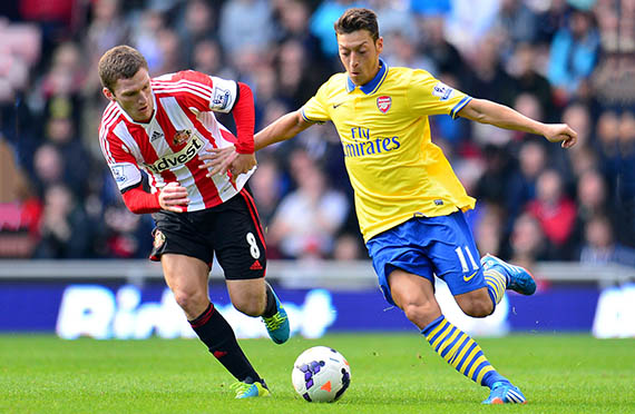 Mesut Ozil and Graig Gardner