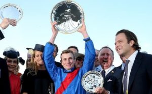 Triumphant Ryan Moore holds the Cox Plate aloft