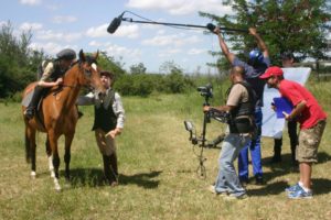 Fransie Herholdt as Alec Laird teaches a young 'Syd' how to ride