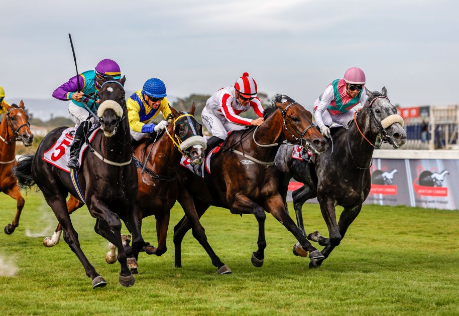 In the tightest finish of the day, Corne Orffer gets Master Redoute up on the outside to beat Triple Time (Van Niekerk) on the inside, with Aragosta (Fourie, red and white) and Nebraas (Lerena) in the mix (Pic - Candiese Lenferna)