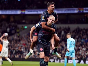 Manchester City's Erling Haaland celebrates scoring their side's second goal of the game with team-mate Rodri during the Premier League match at the Tottenham Hotspur Stadium, London