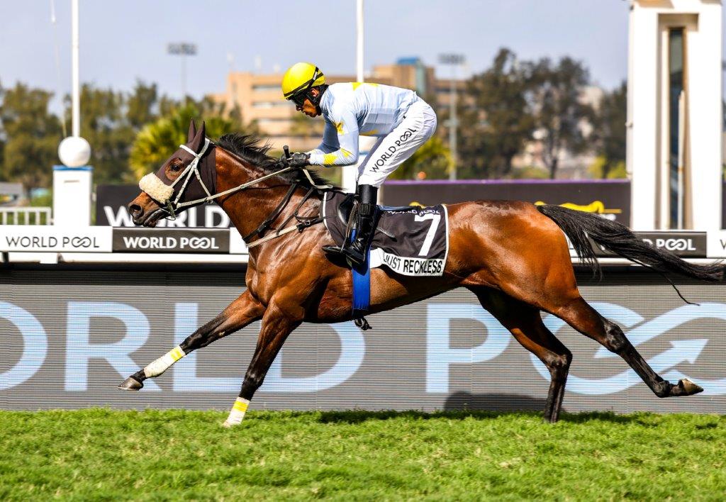 Gr3 Strelitzia Stakes winner Just Reckless powers home under jockey Tristan Godden (Pic - Candiese Lenferna)