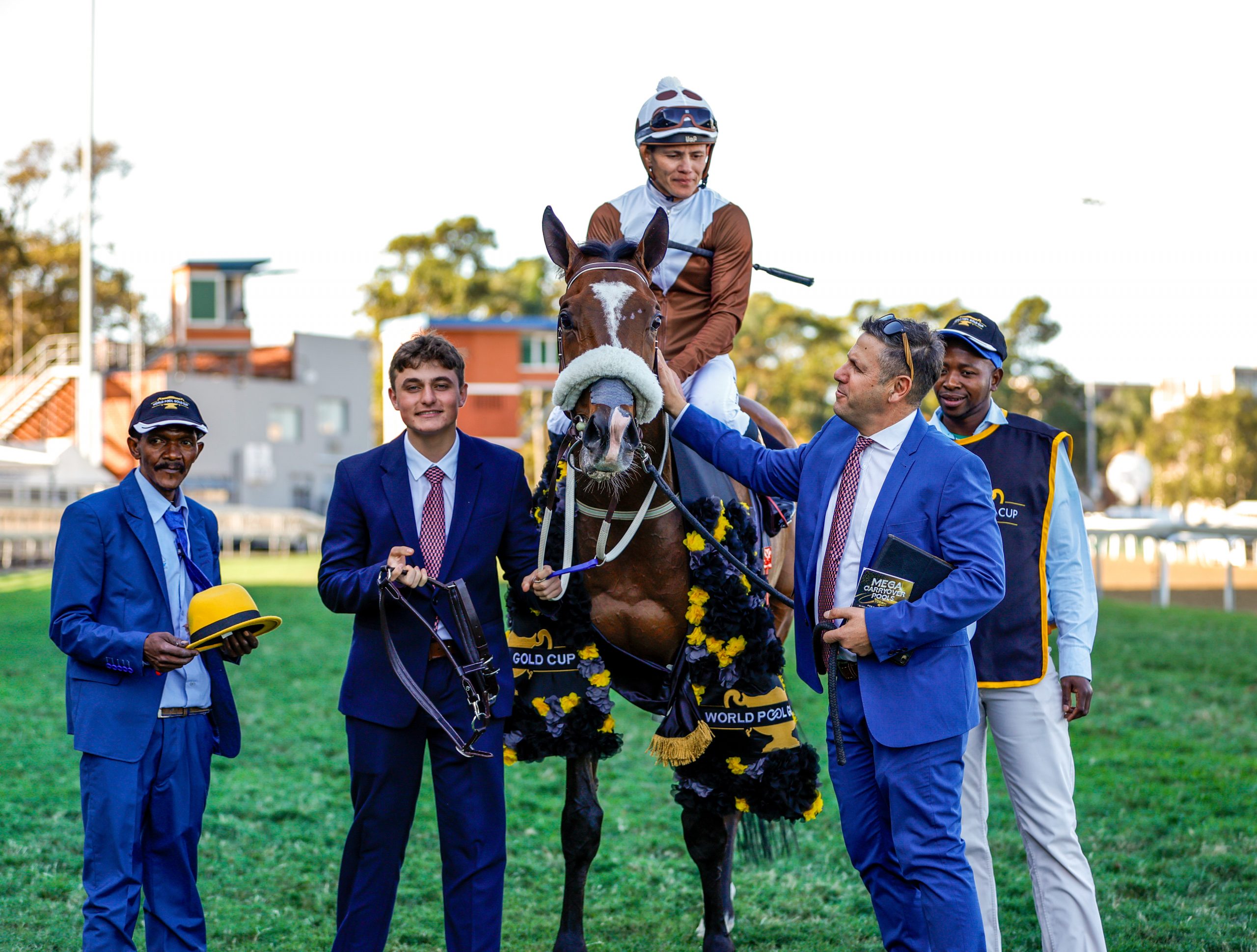 Sean and Daniel Tarry and the Randjesfontein team lead Future Pearl (Richard Fourie) in after his Gold Cup victory last year