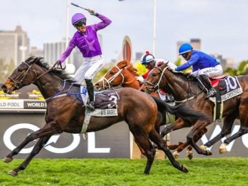 A delighted Calvin Habib salutes as VJ’s Angel storms home to beat The Specialist (Smanga Khumalo) and Grand Crescendo (Muzi Yeni) in a superb finish (Pic – Candiese Lenferna)
