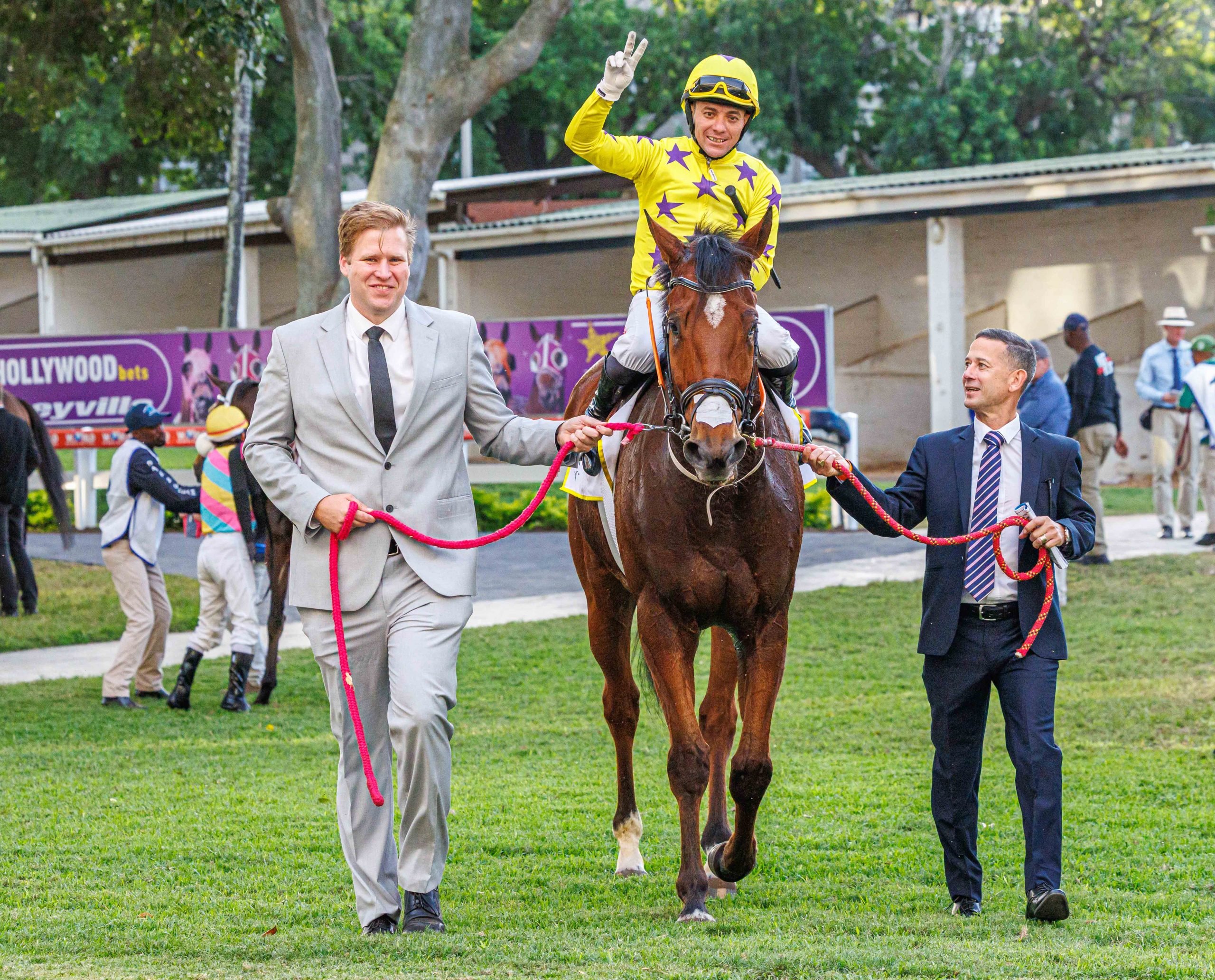 Devin and Anthony Delpech lead Tobacconist (Sean Veale) in after his win in the final race on Saturday (Pic - Candiese Lenferna)